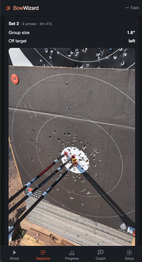 Arrows still in a cardboard target, group read at 1.8 inches