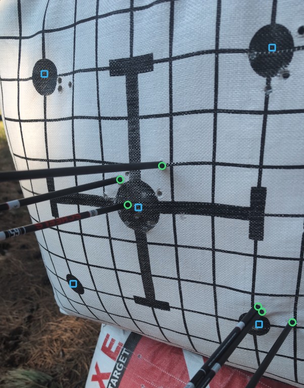 A target photo with every arrow found and each group measured